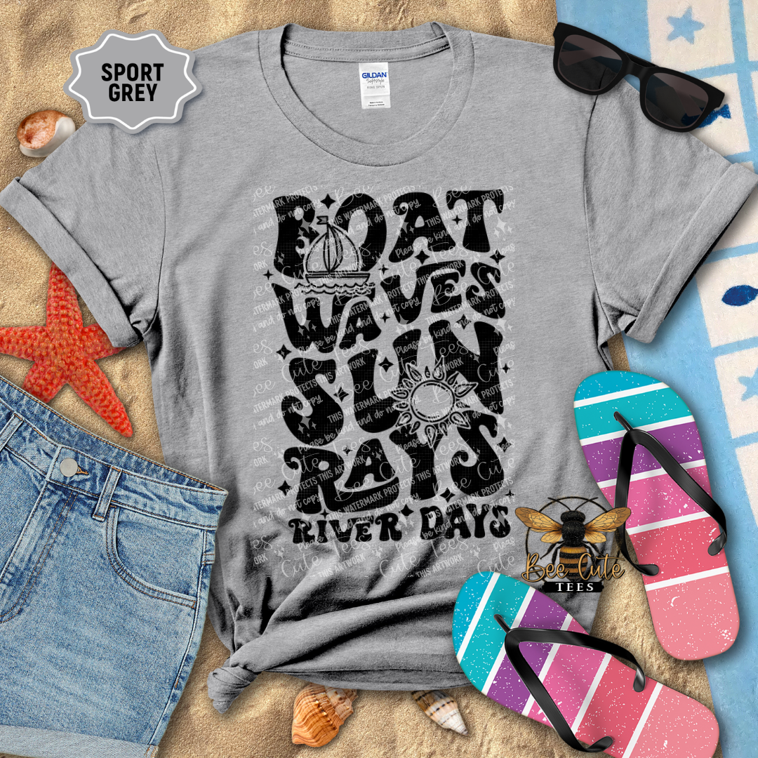 Gray t-shirt with beach-themed design on a surface with sunglasses, flip-flops, and denim shorts.