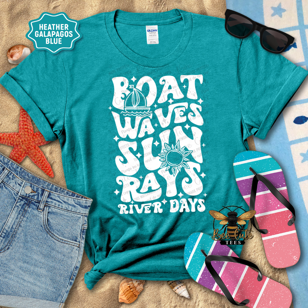 Teal t-shirt with 'Boat Waves Sun Rays River Days' design on a beach-themed background with sunglasses, flip-flops, and starfish.