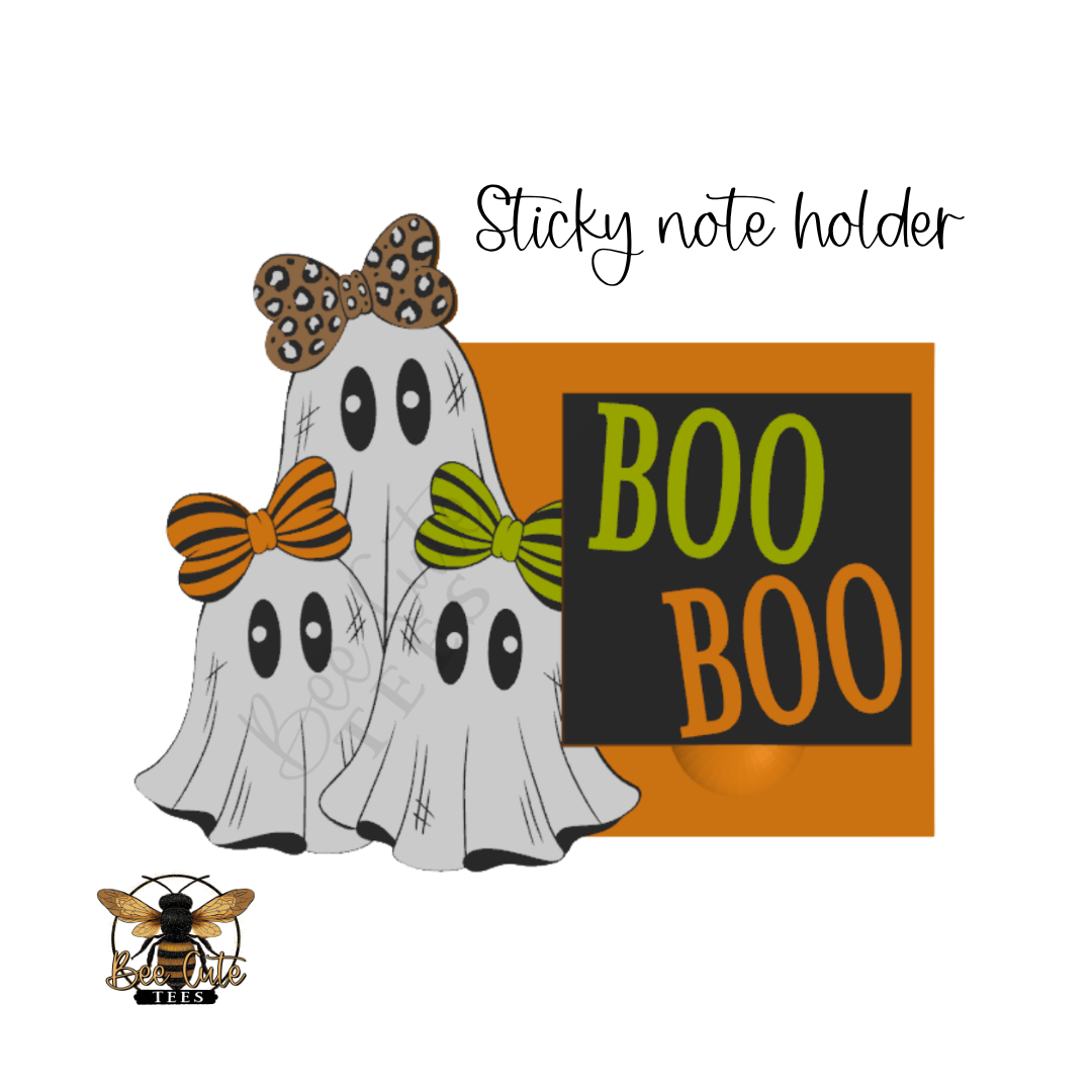 A Halloween-themed sticky note holder design featuring three cartoon ghosts with orange, brown, and green bows next to an orange square with the words 'BOO BOO' in green and orange on a black background. The text 'Sticky note holder' appears above, and a bee logo is shown at the bottom left.