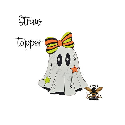 A Halloween-themed ghost topper design on a white background, featuring a white ghost with black eyes, an orange and black striped bow, star accents, and a small bee illustration. The text 'Straw topper' appears above.