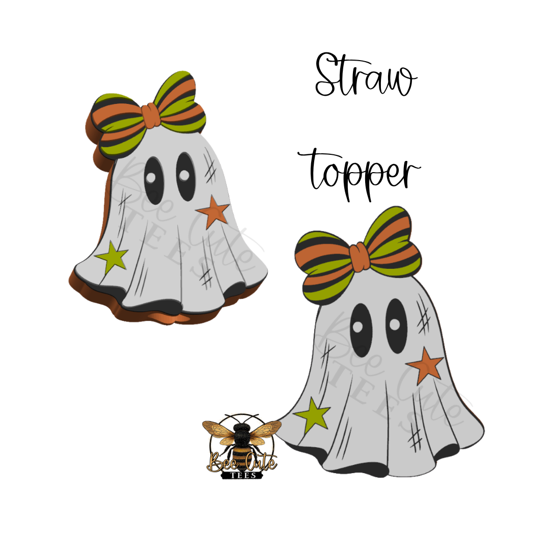 A Halloween-themed ghost topper design shown twice on a white background, with the words 'Straw topper' above it. The ghost is white with black facial features, black scratch marks, a green and orange striped bow, a yellow star, and an orange star.