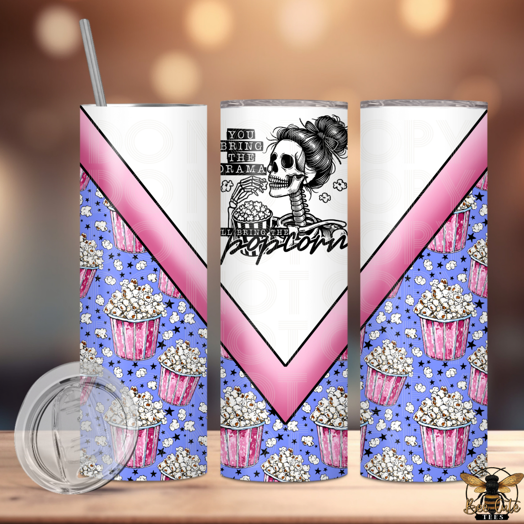 Tumbler with popcorn and skeleton design on a wooden surface