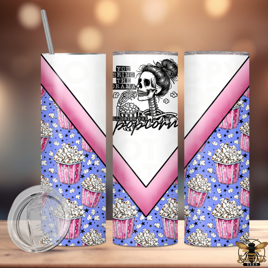 Tumbler with popcorn and skeleton design on a wooden surface