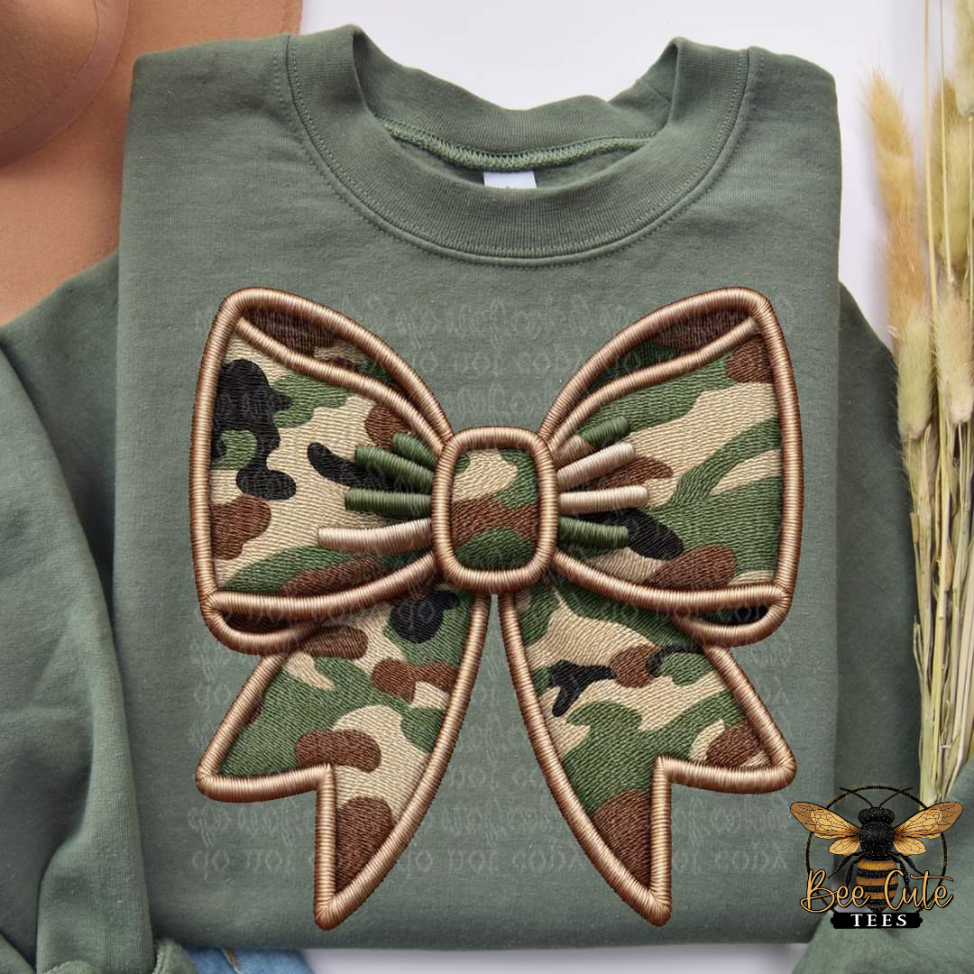 Green sweatshirt with a large camouflage bow patch on a white background