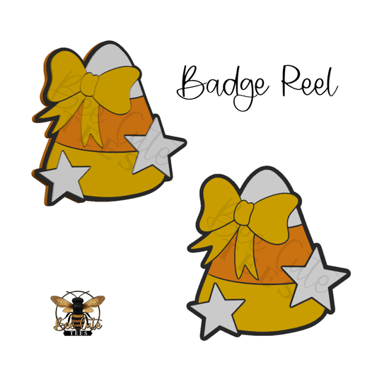 Two identical candy corn badge reel designs with a yellow bow, orange and white stripes, and silver stars, shown on a white background with the text 'Badge Reel' and a small bee logo.