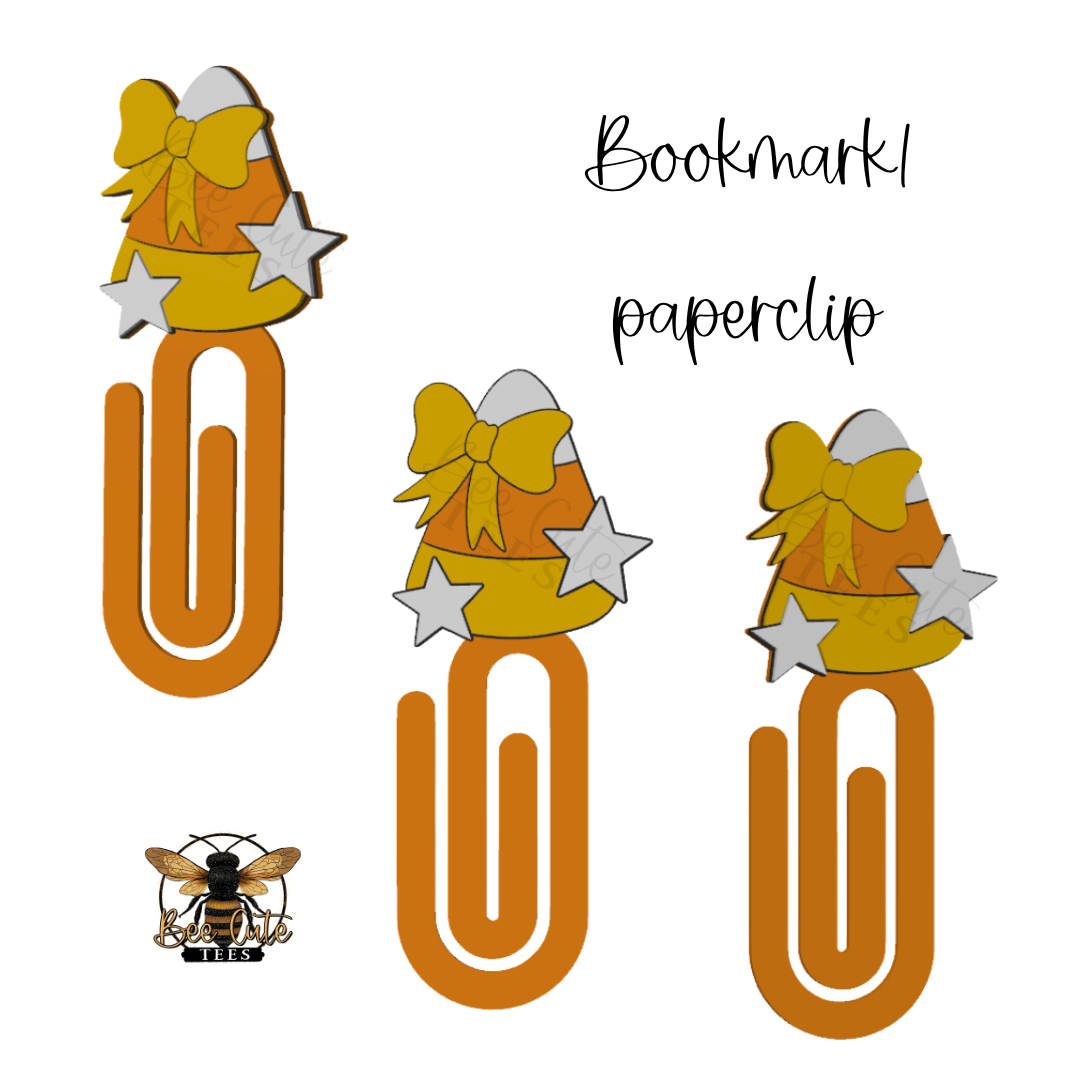 Three orange paperclip bookmarks decorated with yellow bows, white stars, and candy corn tops, shown on a white background with the text 'Bookmark paperclip' and a small bee illustration.