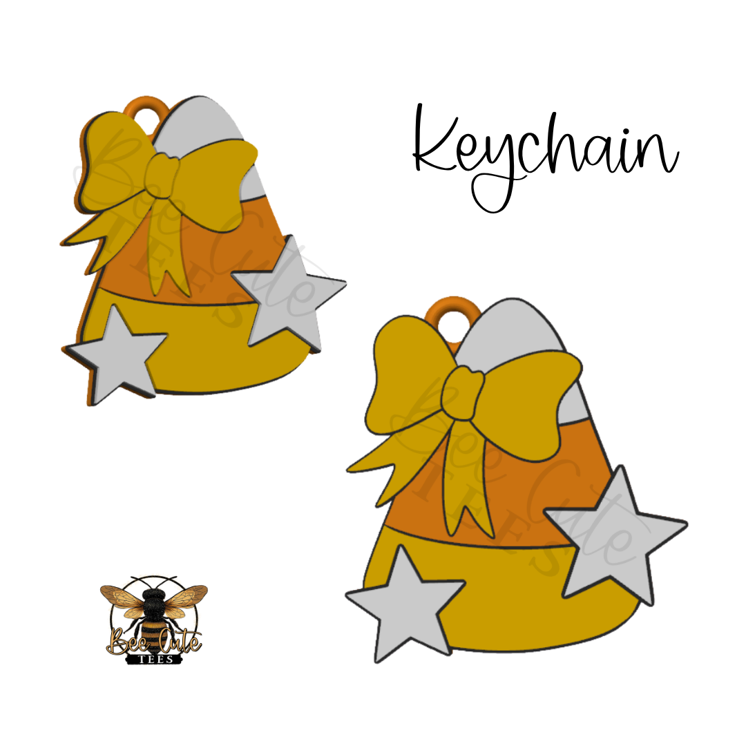 Two candy corn keychain charms with yellow bows and silver stars on a white background, with the word 'Keychain' and a small bee logo.
