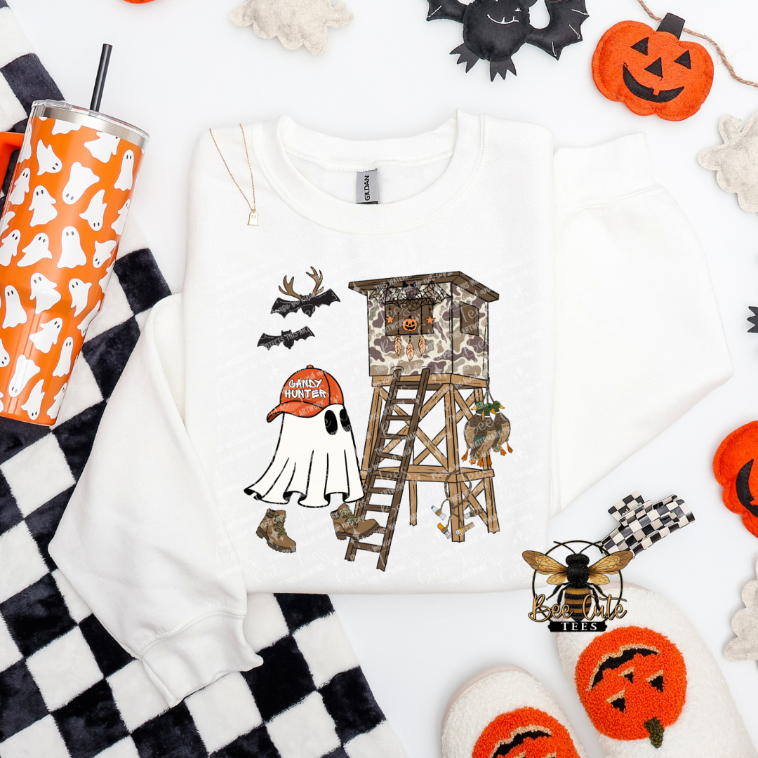 White sweatshirt with Halloween-themed design featuring a ghost, ladder, and pumpkins on a white background.