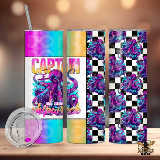 Colorful 20 oz tumbler featuring a vibrant purple octopus design with checkerboard accents and retro gradient panels, paired with “Captain of the Shipwreck” wording, displayed with a lid and metal straw against a softly lit background.
