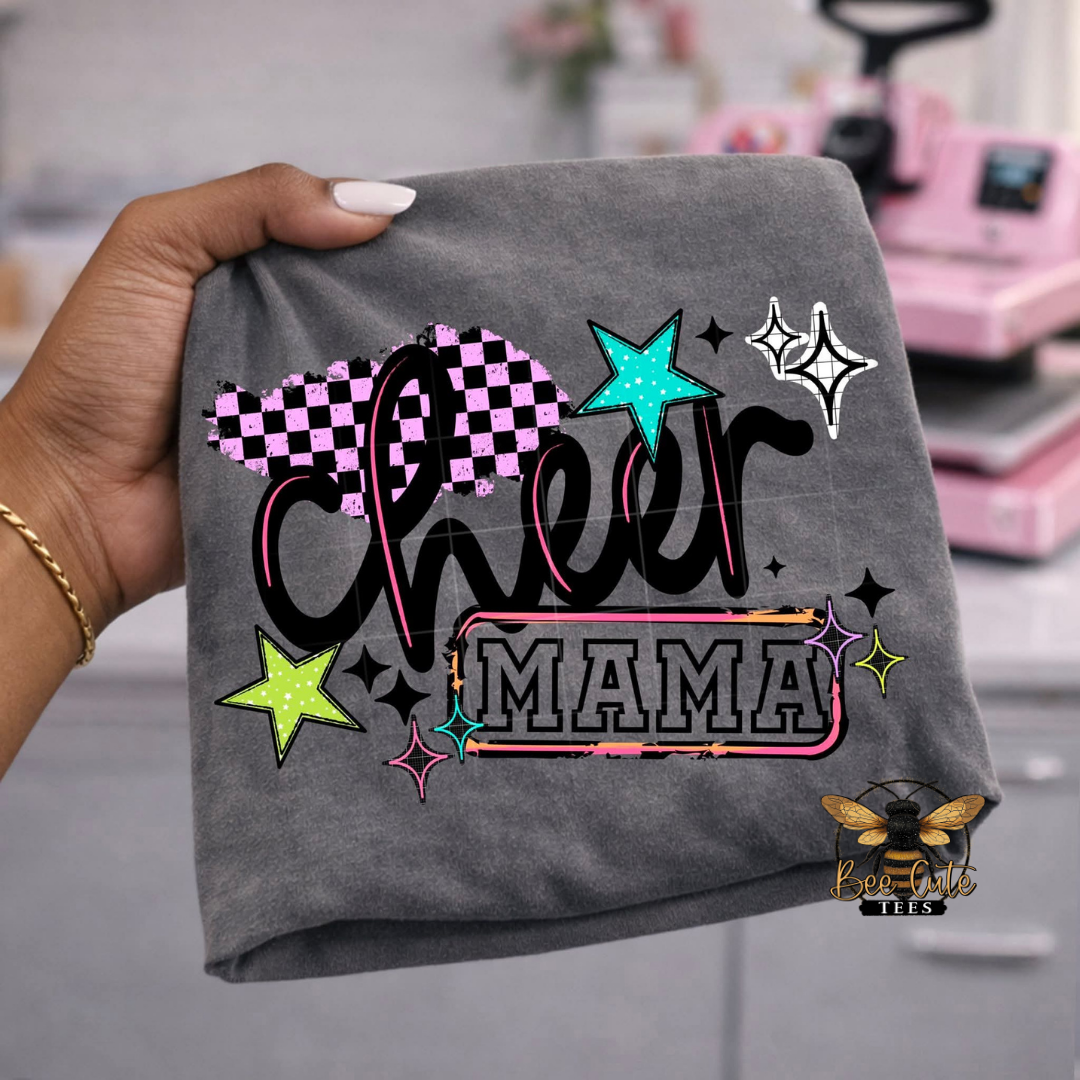 Gray t-shirt with 'Cheer Mama' text and decorative stars held by a hand.