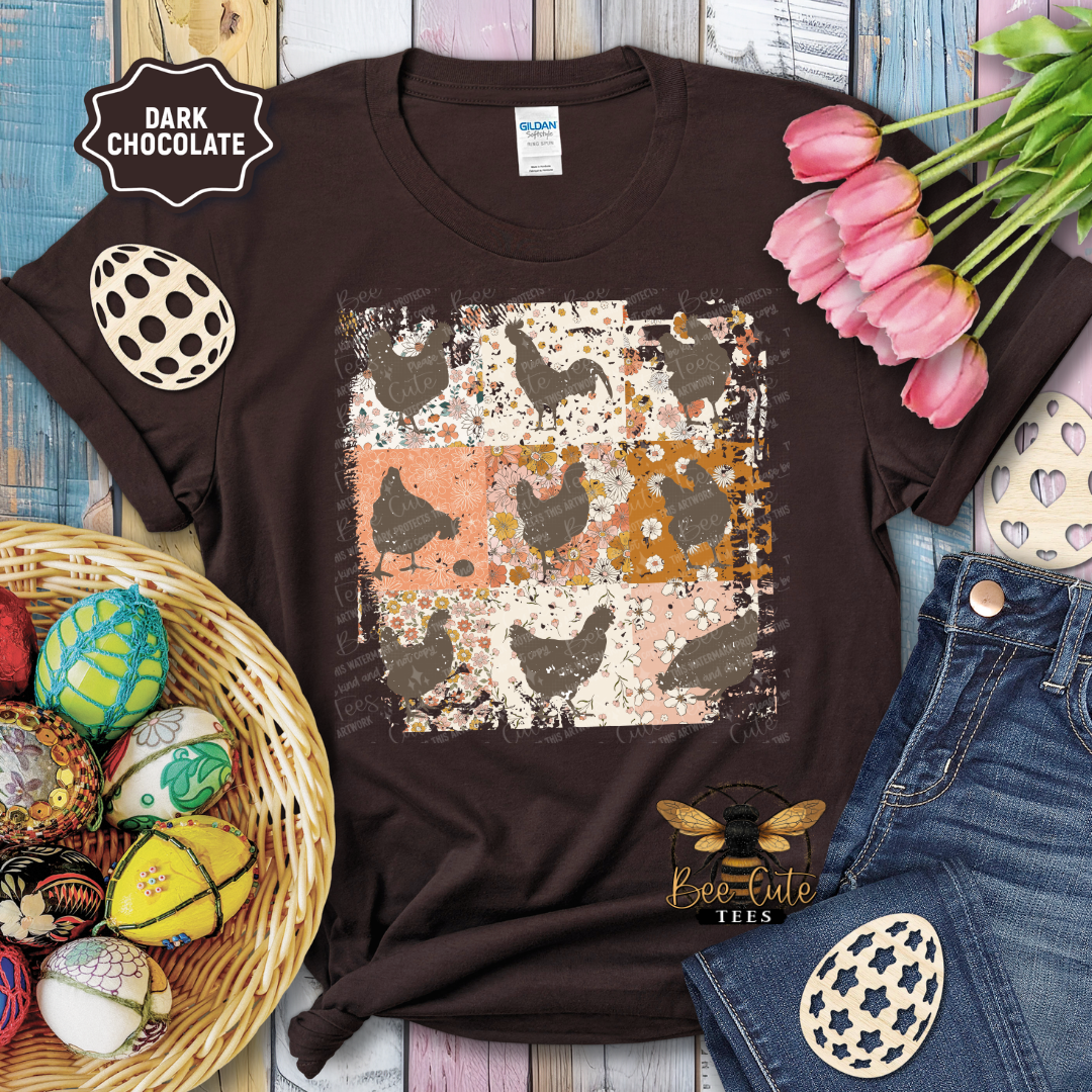 Brown t-shirt with chicken and floral pattern, surrounded by Easter decorations on a wooden surface.