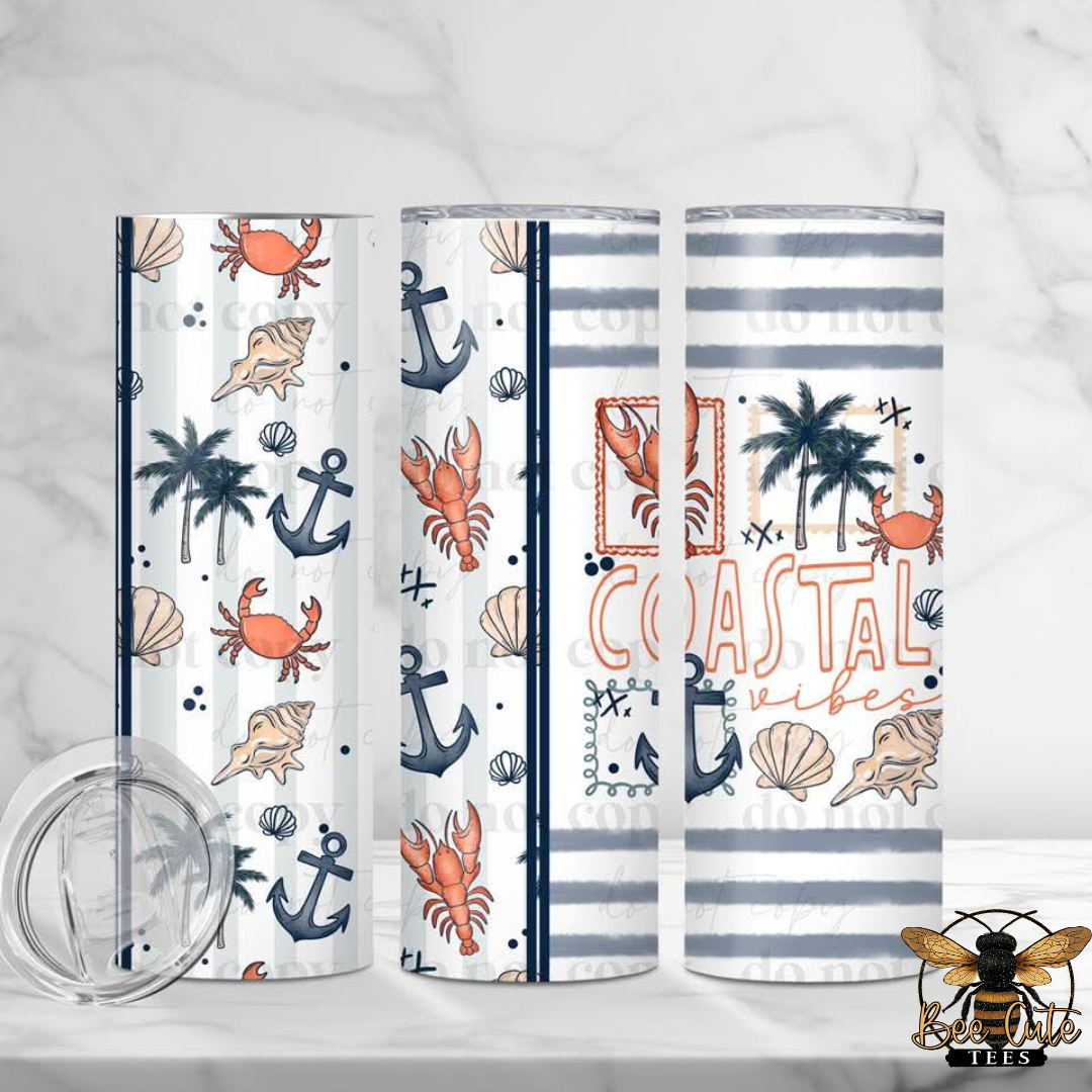 Set of three tumblers with coastal designs on a white background