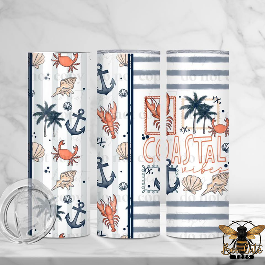 Set of three tumblers with coastal designs on a white background