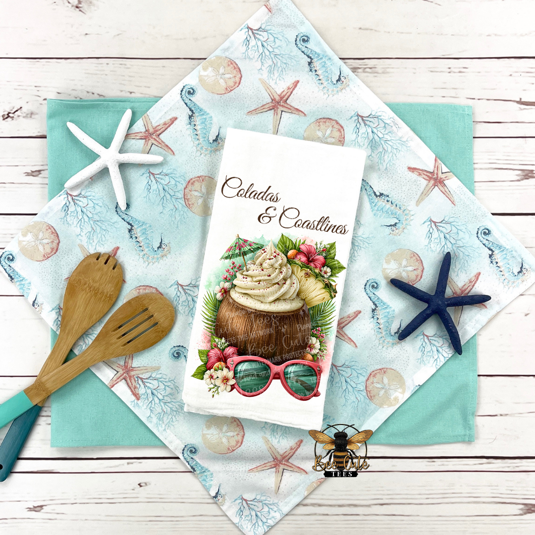 Tea towel with a tropical design featuring a coconut and sunglasses on a decorative napkin with starfish and shell pattern.