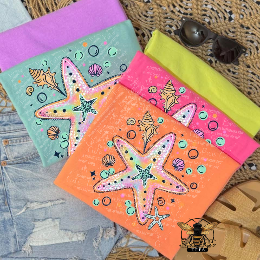 Colorful notebooks with starfish designs on a textured surface