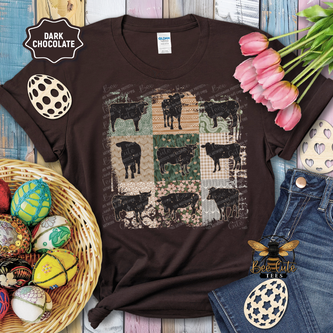 Brown t-shirt with cow pattern on a wooden surface with decorative items.
