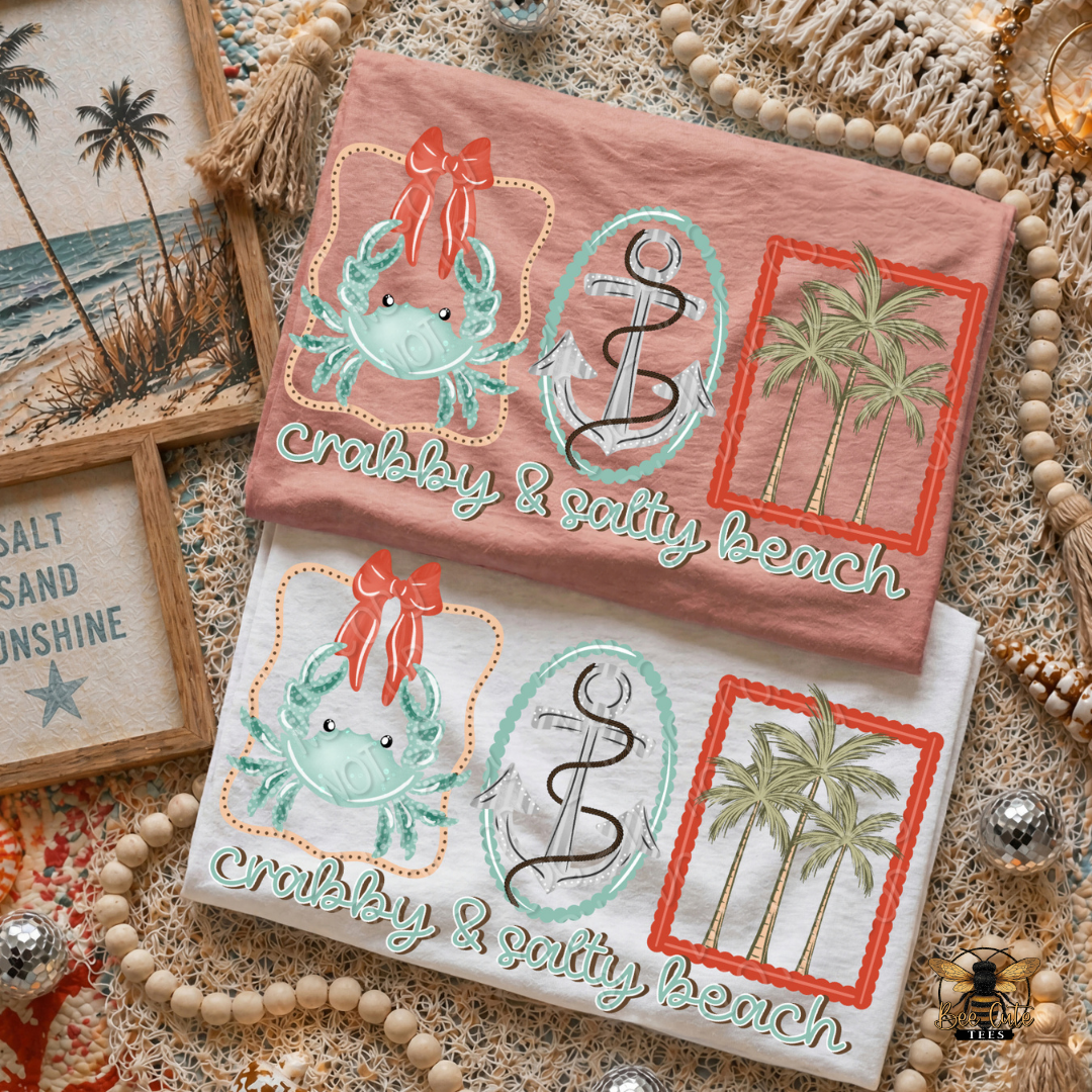 Two t-shirts with beach-themed designs on a textured surface.