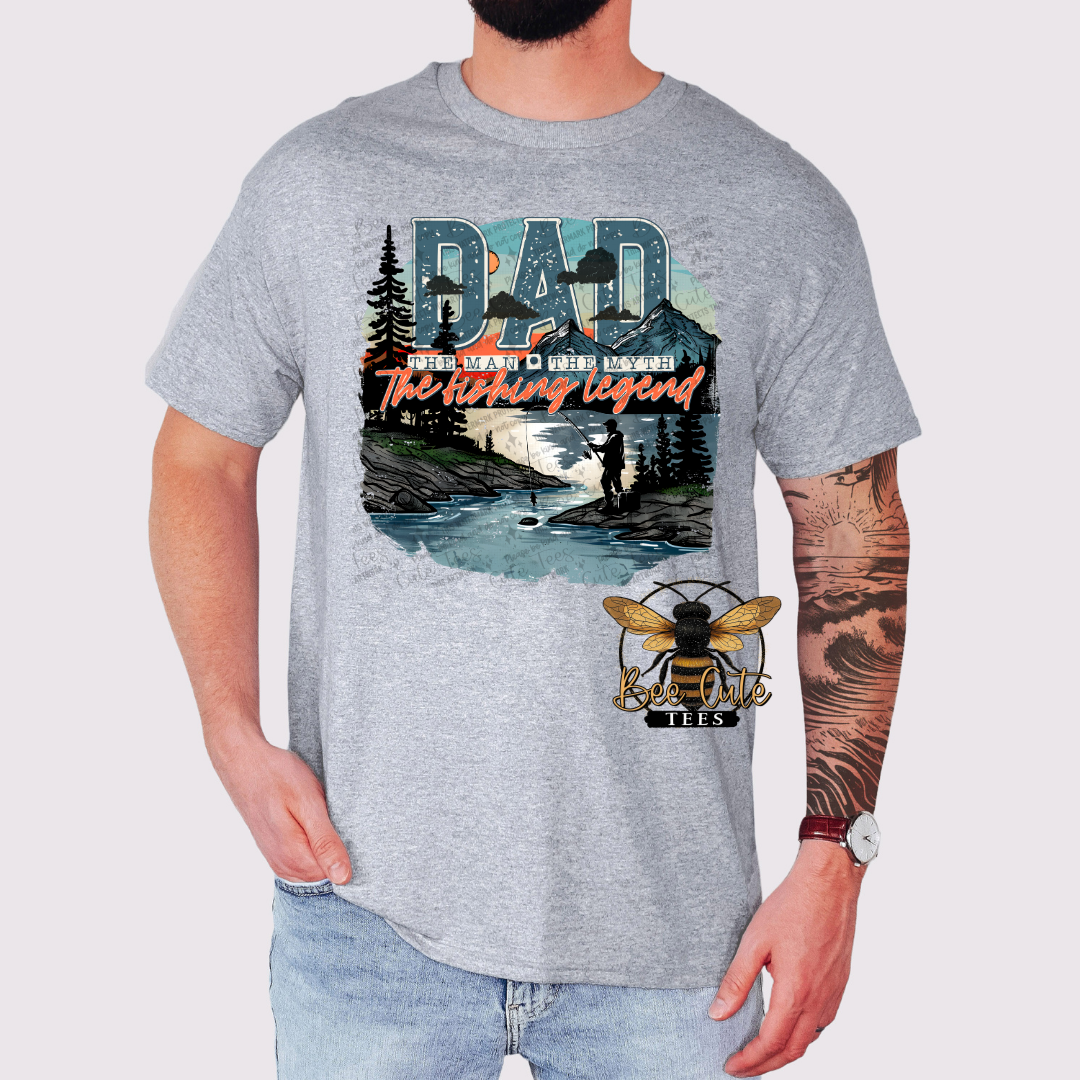 Gray t-shirt with a graphic design featuring a river scene and text, worn by a person.