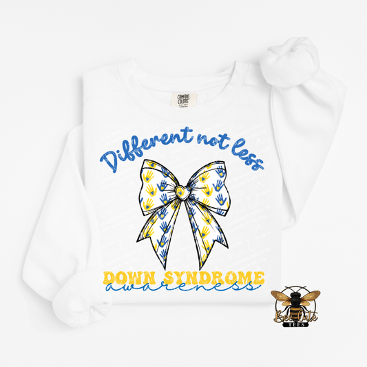 White sweatshirt with a bow design and text about Down Syndrome awareness on a white background.