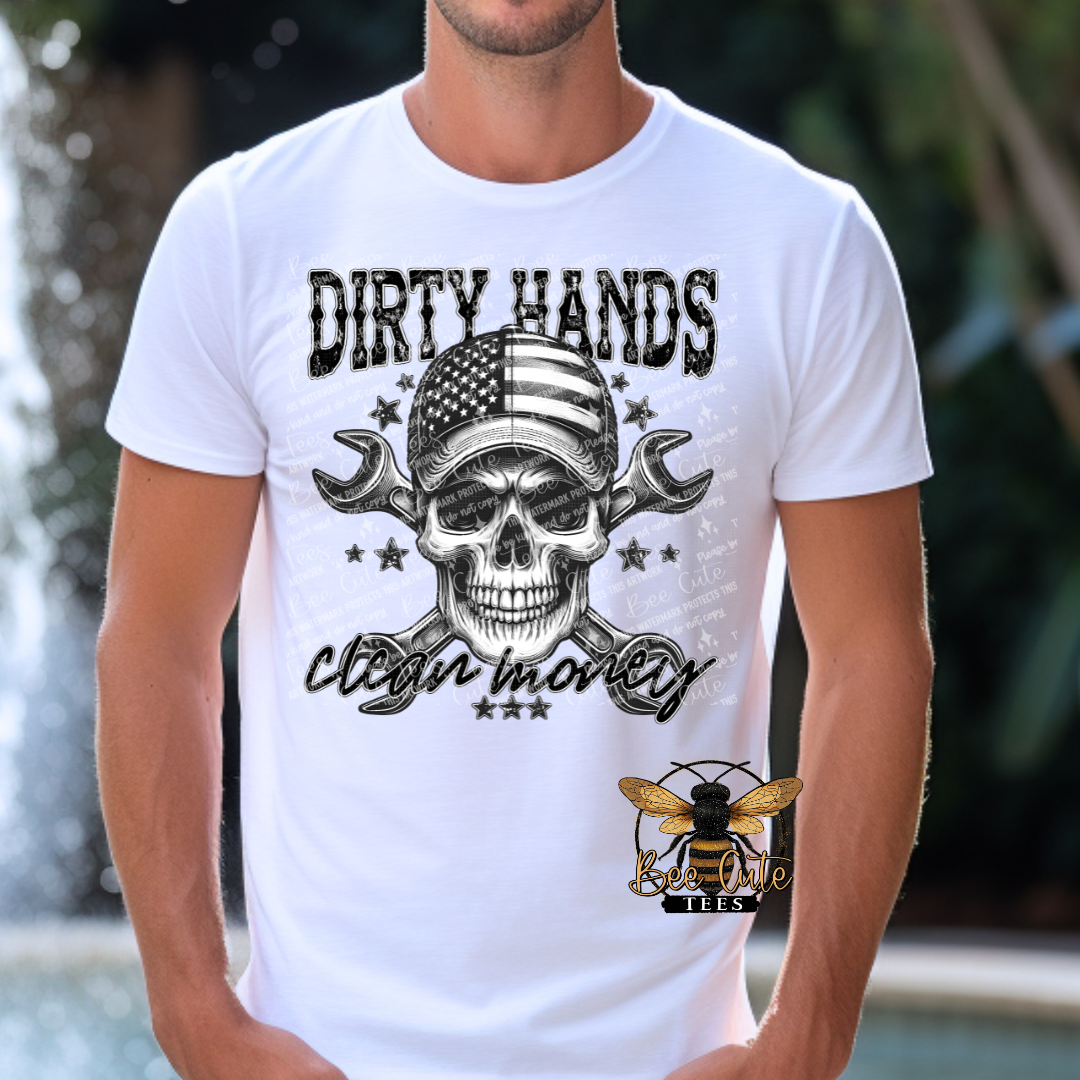 Man wearing a white graphic tee featuring a skull with an American flag bandana and crossed wrenches, paired with the phrase “Dirty Hands, Clean Money” in bold distressed lettering.
