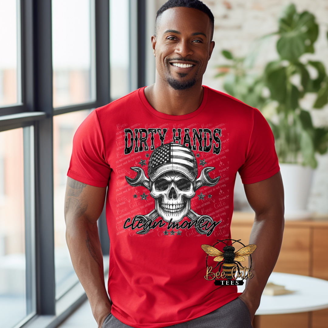 Man wearing a red graphic tee featuring a skull with an American flag bandana and crossed wrenches, paired with the phrase “Dirty Hands, Clean Money” in bold distressed lettering.
