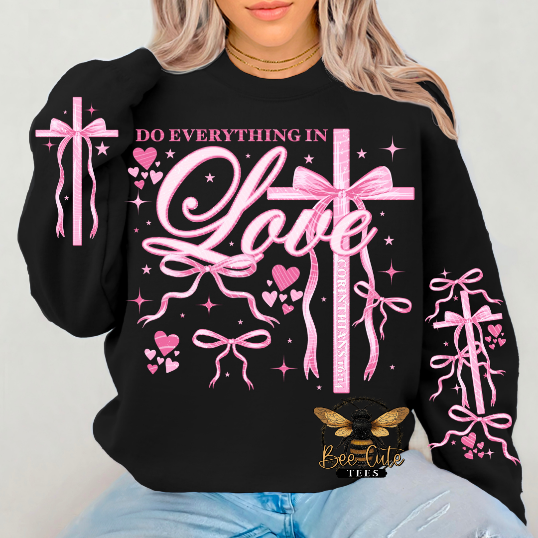 Black sweatshirt with pink graphics and text 'Do Everything in Love' on a plain background
