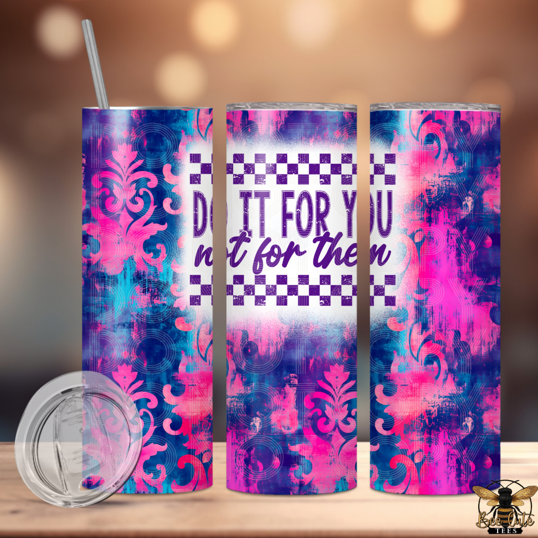 Three colorful tumblers with decorative patterns and text on a wooden surface.