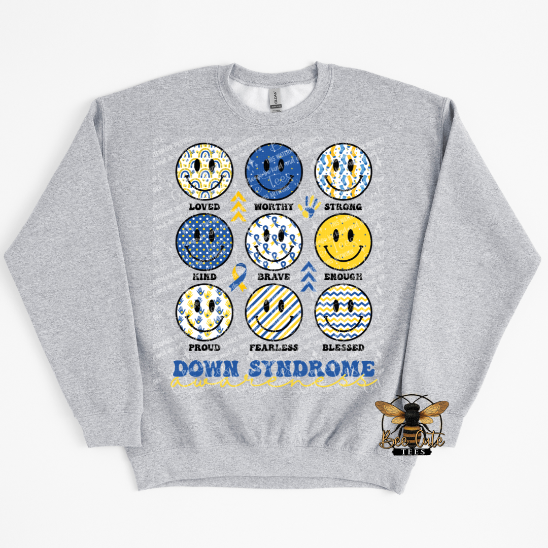Gray sweatshirt with smile face designs and motivational text on a white background