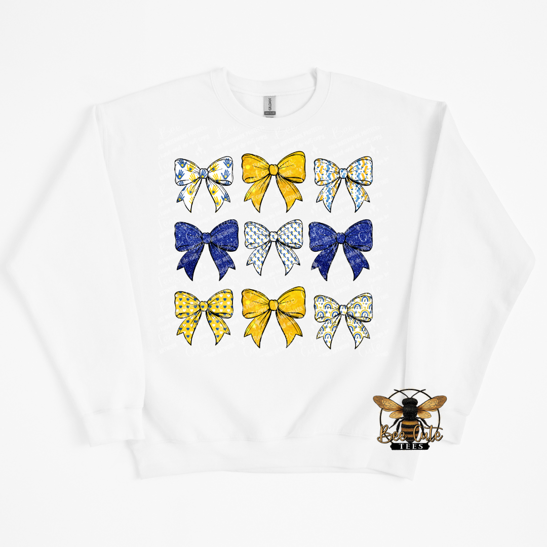 White sweatshirt with colorful bow designs and a bee logo on a white background