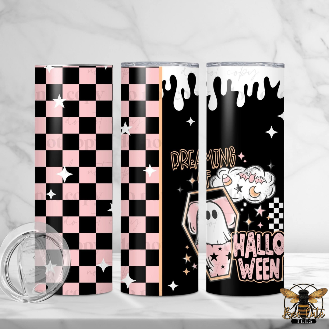 Three slim tumblers with Halloween-themed designs displayed on a white marble surface. The designs include a pink and black checkerboard pattern, a black background with white dripping paint and a ghost illustration, and a black background with a pink and white checkerboard pattern and the words 'HALLOWEEN'.