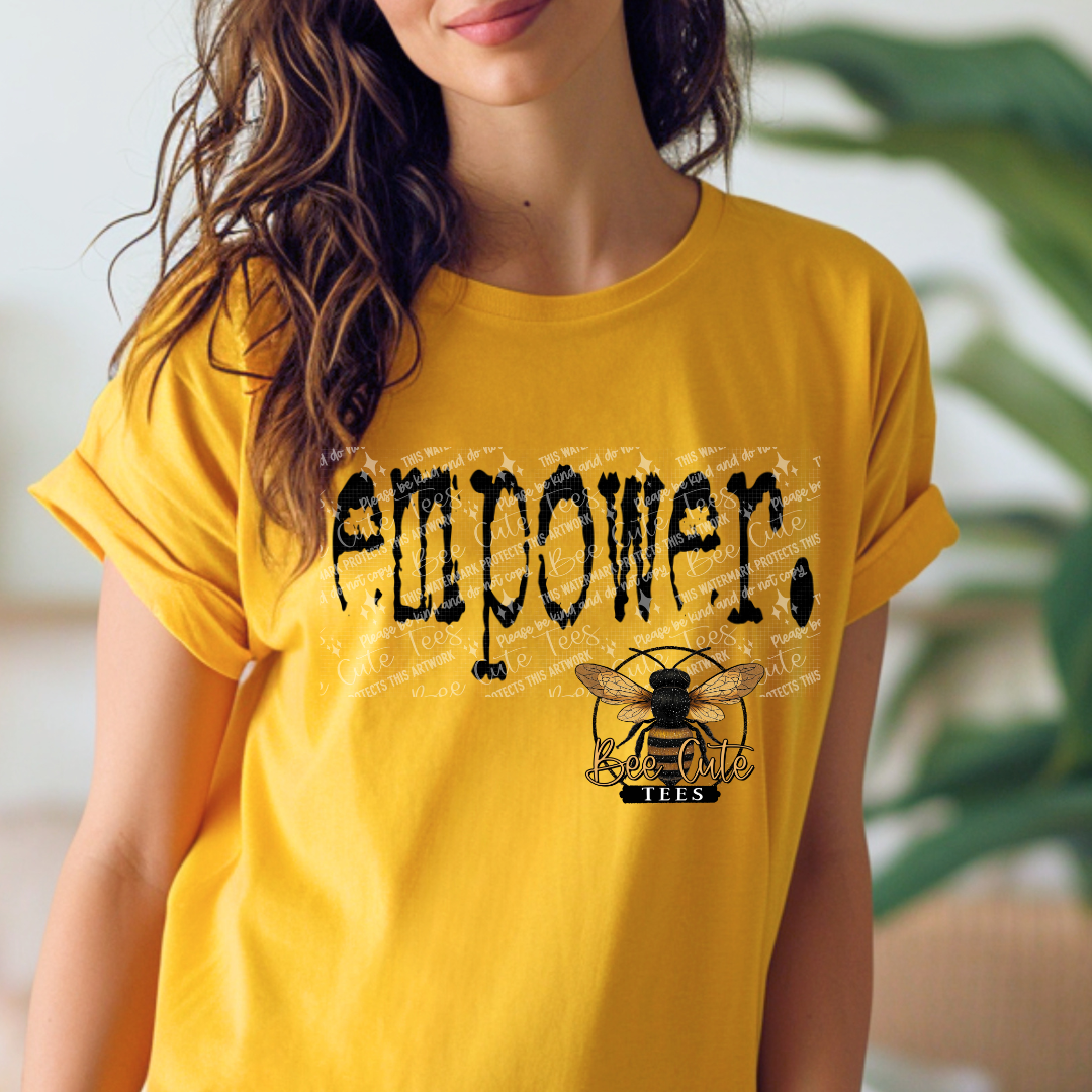 Person wearing a yellow t-shirt with 'EMPOWER' and a bee logo.