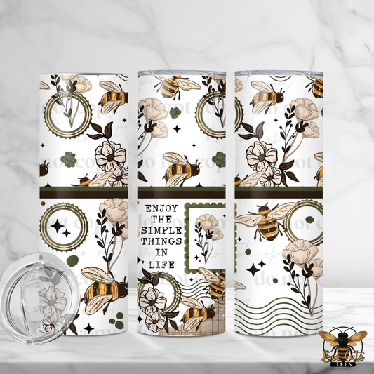 Three tumblers with floral and bee design on a white background