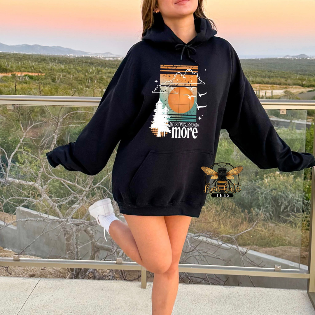 Person wearing a black hoodie with a graphic design outdoors