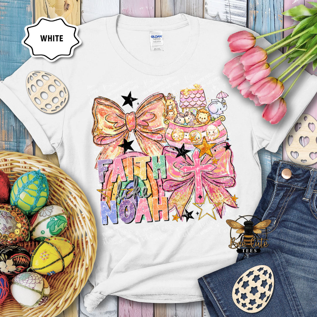 White t-shirt with colorful design featuring bows and text, surrounded by Easter decorations.