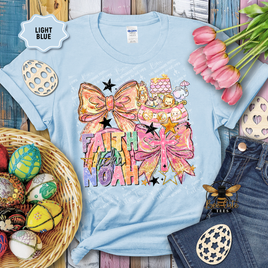 Light blue t-shirt with decorative design and text, surrounded by Easter eggs and tulips.