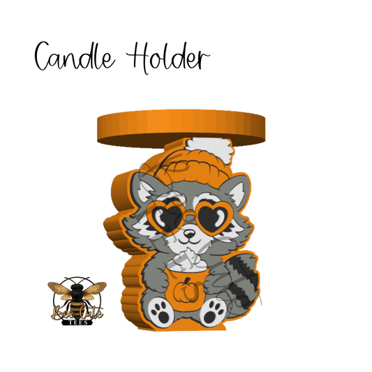 A 3D digital rendering of a cartoon raccoon candle holder in a fall/Halloween theme. The raccoon is gray with black and white stripes, wearing an orange knit beanie and heart-shaped sunglasses, holding a pumpkin bucket filled with white popcorn.