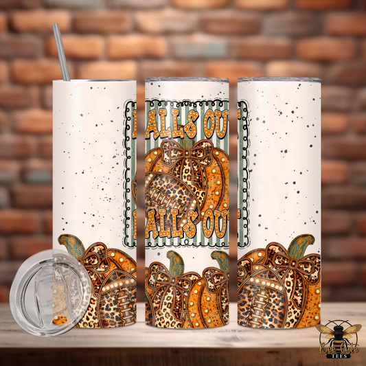 Three views of a 20oz stainless steel skinny tumbler with a white speckled background and an autumn 'Halloween Falls Out' design featuring patterned pumpkins. A clear lid with a metal straw is shown in the foreground against a brick wall background.