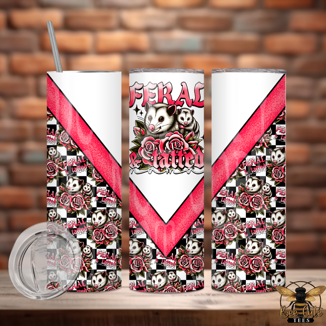 Tumbler with 'Feral Kitties' design featuring cats, roses, and a red chevron pattern on a brick background.