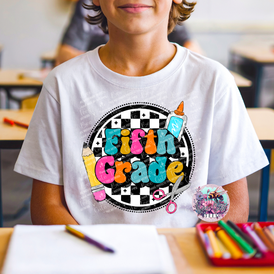 Child wearing a white t-shirt with 'Fifth Grade' design in a classroom setting