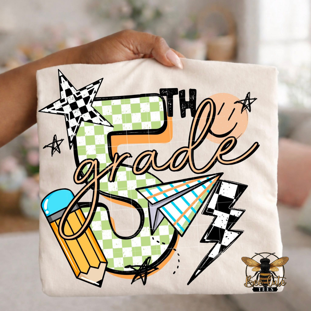 Folded white-colored unisex T-shirt held up by a hand, featuring a colorful "5th Grade" graphic. The design includes green checkered number four, bold black lettering, peach script, a pencil, paper airplane, smiley face, lightning bolt, stars, and playful doodles. A fun, retro-inspired back-to-school design perfect for fourth grade teachers and students.
