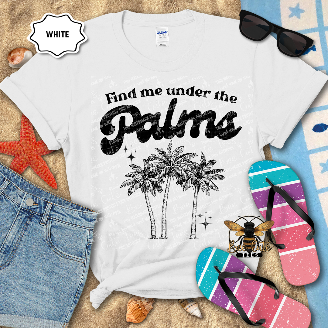 White t-shirt with 'Find me under the palms' design on a beach-themed background