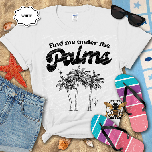 White t-shirt with 'Find me under the palms' design on a beach-themed background