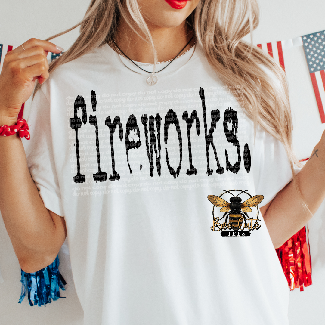 A person wearing a white crewneck t-shirt with 'Fireworks' printed in black typography on the front.