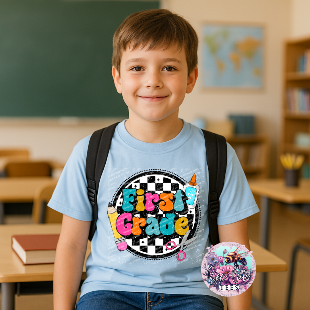 Young boy in a classroom wearing a 'First Grade' t-shirt with a backpack.