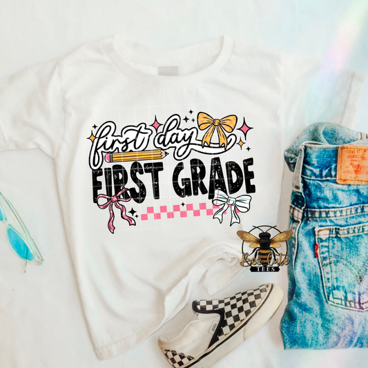 White t-shirt with 'first day first grade' text, denim shorts, and checkered shoes on a white background.