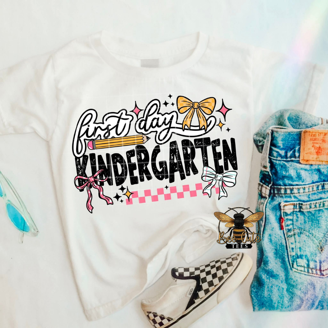 White sweatshirt with 'first day kindergarten' text, denim shorts, and checkered shoes on a white background.