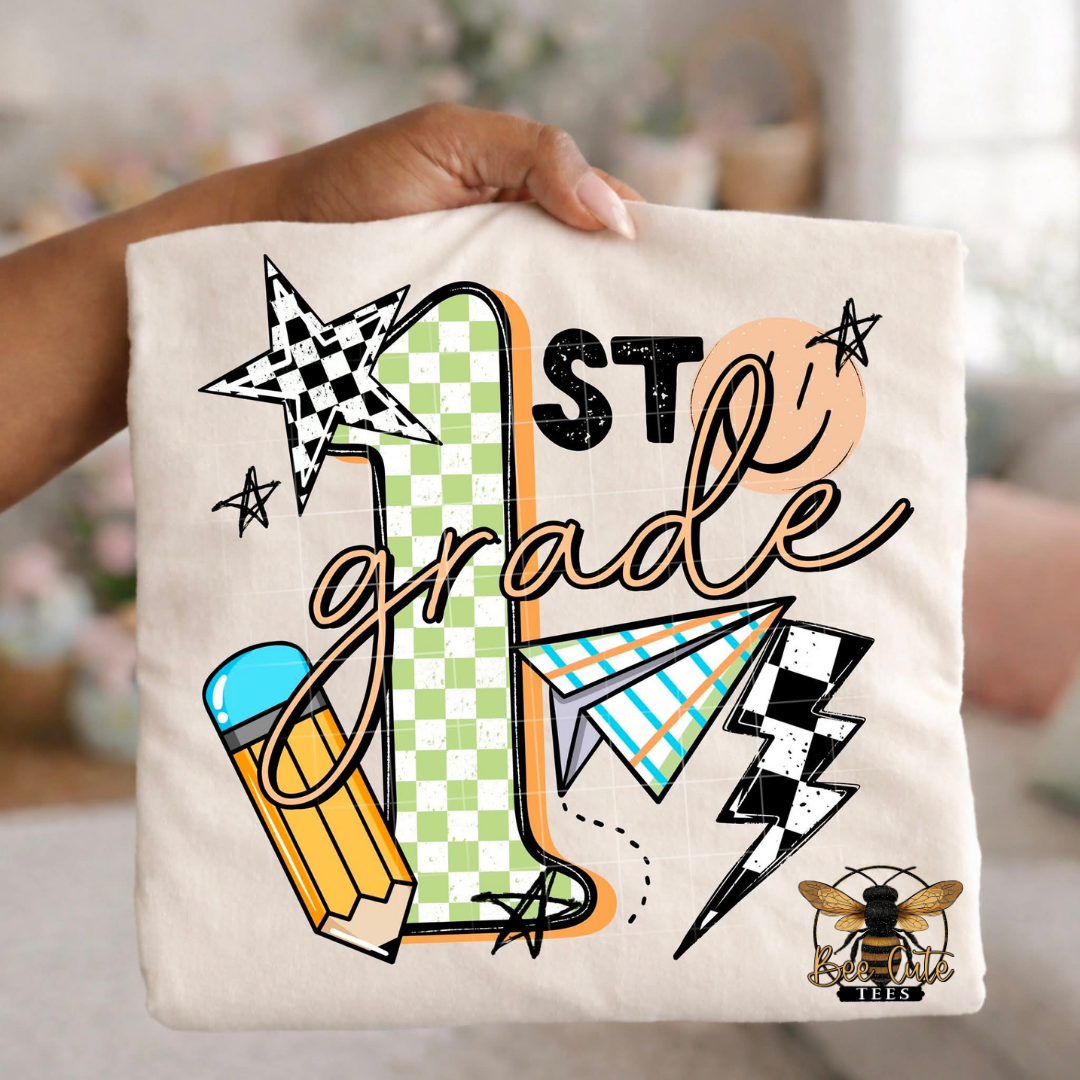 Folded white-colored unisex T-shirt held up by a hand, featuring a colorful "1st Grade" graphic. The design includes green checkered number four, bold black lettering, peach script, a pencil, paper airplane, smiley face, lightning bolt, stars, and playful doodles. A fun, retro-inspired back-to-school design perfect for fourth grade teachers and students.
