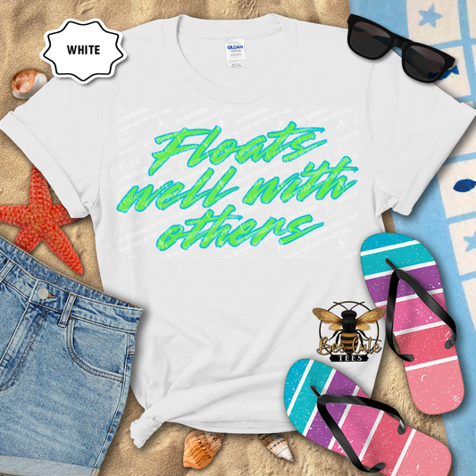 White t-shirt with colorful text, sunglasses, and flip-flops on a beach-themed background