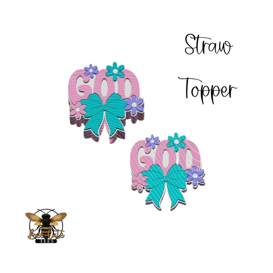 Two pink and teal straw toppers with flowers and the word 'GOD' on a white background.