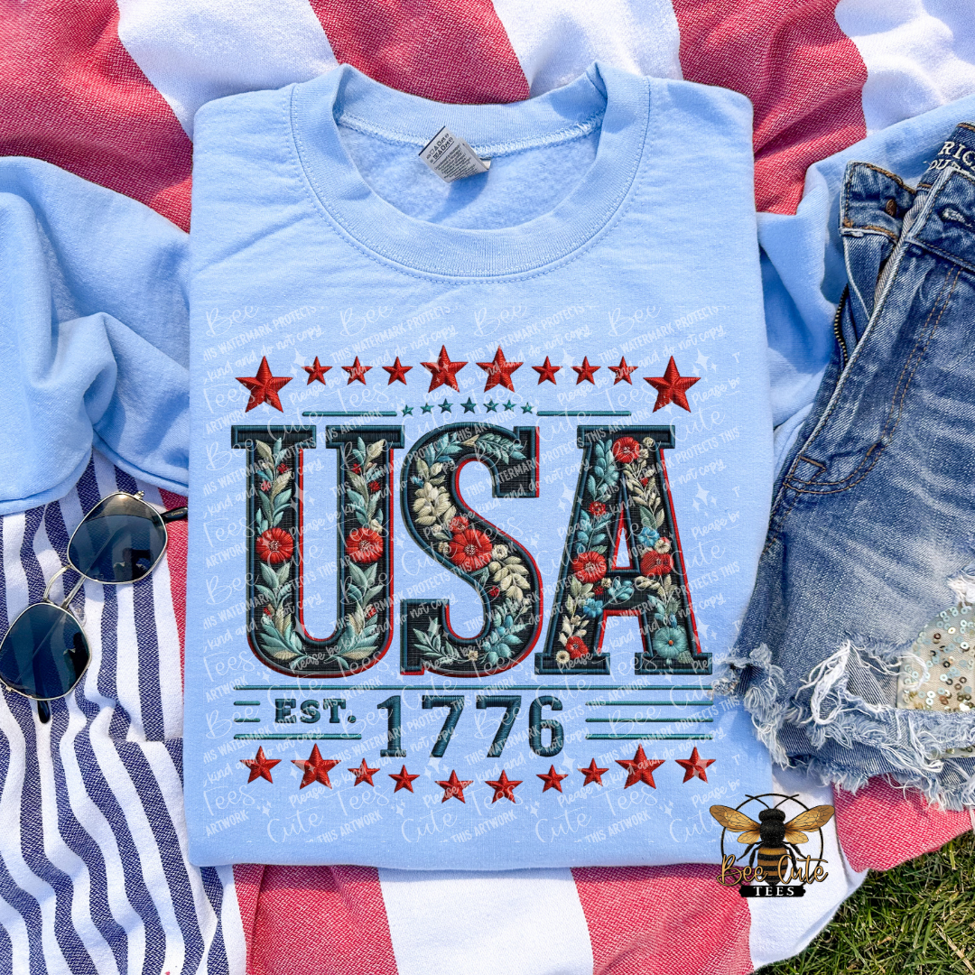 Light blue t-shirt with 'USA' design on a flag background
